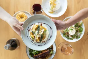 overhead image of beautifully plated food and wine