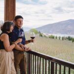 couples wine tasting on the patio overlooking Okanagan Lake