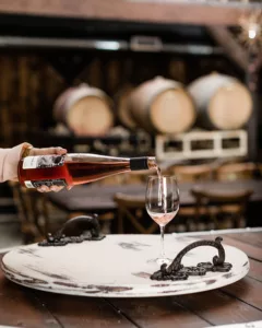 pouring rose wine into glass