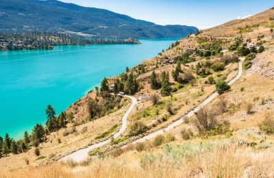 Great view on Kalamaka lake in British Columbia, Canada. Large luxury houses on the lake shore with view on the water and mountain ridge